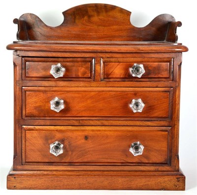 Lot 1480 - A Flame Mahogany Miniature Chest, in the form of a Victorian chest of drawers, with...