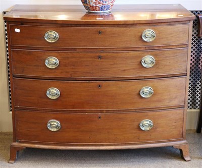 Lot 1485 - A George III Mahogany Bowfront Chest of Drawers, early 19th century, of four graduated drawers with