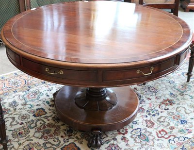 Lot 1505 - A Victorian Mahogany and Crossbanded Circular Drum Table, mid 19th century, with four real and four