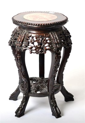 Lot 1511 - A Chinese Padouk Wood and Pink Marble Plant Stand, early 20th century, with foliate carved...