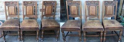 Lot 1536 - A Set of Six Victorian Carved Oak Dining Chairs, circa 1890, upholstered in close-nailed brown...