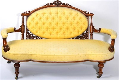 Lot 1538 - A Victorian Walnut Framed Sofa, circa 1870, recovered in yellow button-back fabric with an oval...