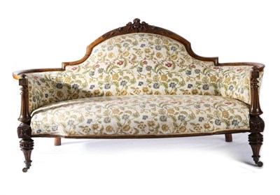 Lot 1539 - A Victorian Walnut Framed Sofa, circa 1870, recovered in floral fabric with padded back...