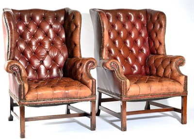 Lot 1541 - A Pair of 20th Century Wing-Back Armchairs, upholstered in close-nailed and button brown...