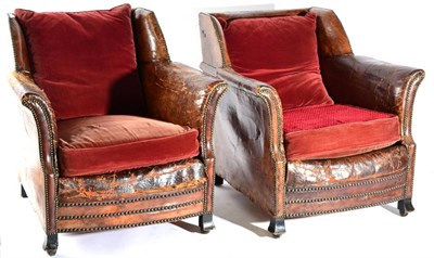 Lot 1543 - A Pair of Early 20th Century Club Armchairs, upholstered in close-nailed worn brown leather...