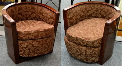 Lot 1555 - A Pair of 1930s Walnut Framed Tub Chairs, recovered in brown floral fabric with curved back...