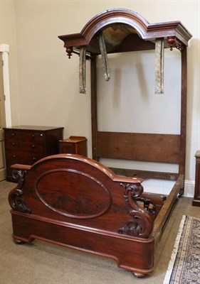 Lot 1561 - A Victorian Carved Mahogany Half Tester Bed, mid 19th century, with a moulded canopy top above...