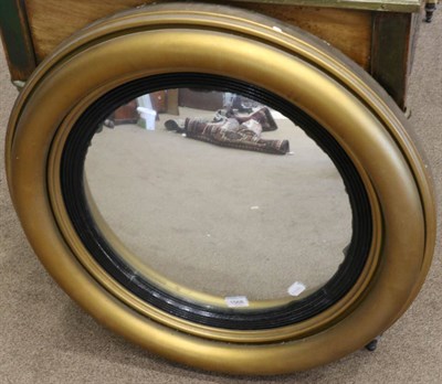 Lot 1568 - A Regency Style Gilt Circular Convex Wall Mirror, late 19th century, with ebonised and reeded slip