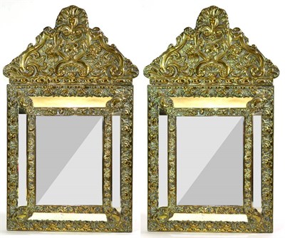 Lot 1569 - A Pair of 19th Century Brass Repoussé Decorated Wall Mirrors, of rectangular marginal form,...