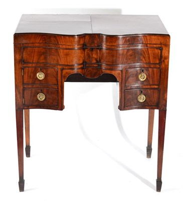 Lot 1580 - A George III Mahogany Serpentine Shape Dressing Table, late 18th century, with hinged leaves...