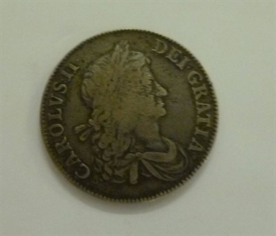 Lot 323 - Charles II Crown 1662, no rose, edge undated, metal flaws on bust and rev. centre worn, good...