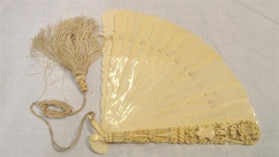 Lot 21 - A 19th Century Ivory Fan, with shaped sticks and an elaborate foliate carved guard in a blue...