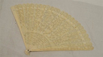 Lot 22 - A 19th Century Carved Ivory Brisee Fan, with twenty-three ivory sticks pierced and carved with...
