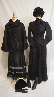 Lot 49 - A Circa 1900 Black Silk Two Piece, with a fitted long sleeved bodice and full skirt trimmed in...