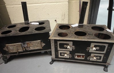 Lot 1014 - Two Black Painted Dolls Stoves with chimneys and saucepans, 26 cm by 18 cm by 13 cm; also chocolate