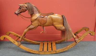 Lot 1020 - Modern Unpainted Carved Rocking Horse bearing a plaque 'Handmade by H Wakefield,Boston' with a...