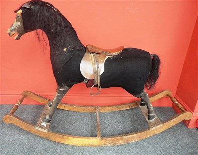 Lot 1025 - Large 19th Century Carved Pine Rocking Horse with glass eyes, recovered and patched with black...