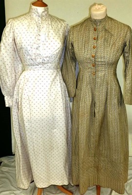 Lot 1131 - Three 19th Century Cotton Dresses including a White Cotton Dress Printed In Red buttons to the...