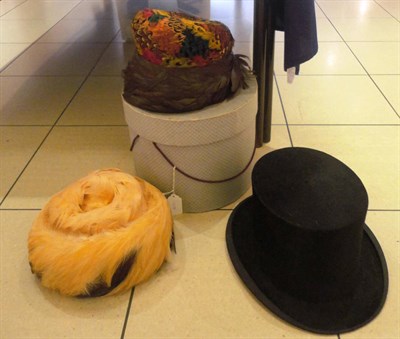 Lot 1133 - Henry Heath Ltd Black Silk Top Hat, Pheasant Feather Trimmed Hat, one other and a hat box