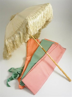 Lot 1151 - Carved Ivory Handled Parasol with cream silk mount and tassel trim, together with replacement silks