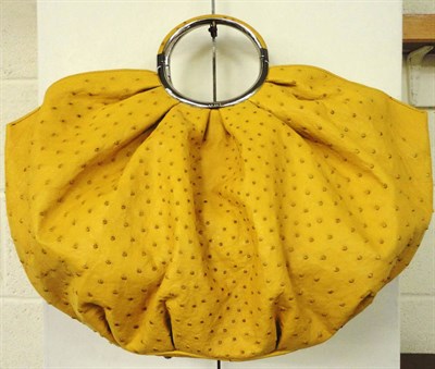 Lot 1171 - Christian Dior Yellow Ostrich Leather 'Babe' Handbag, limited edition 052, with hinged circular...