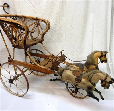 Lot 1016 - G & J Lines New Galloping Horse Carriage', comprising a bamboo seat on a white painted metal...