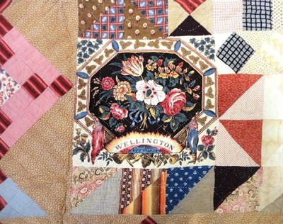 Lot 1040 - Large 19th Century 'Duke of Wellington' Patchwork Quilt with a central diamond, surrounded by...