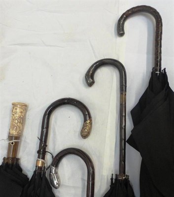 Lot 1076 - Four Black Silk S Fox & Co Paragon Parasols, some with silver mounts to the handle; another with an
