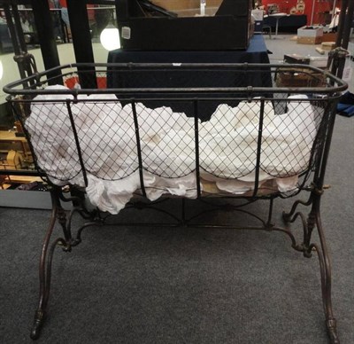 Lot 1083 - Victorian Cast Iron Swing Cradle on Stand with brass mounts, white cotton drapes; and a White Quilt