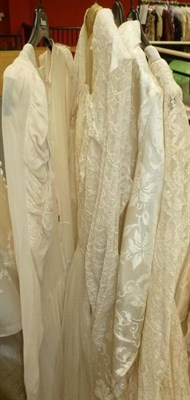 Lot 1136 - Circa 1940's and 50's Wedding Dresses including a Cream Silk Crepe Wedding Gown with long...