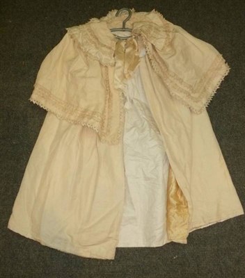 Lot 1149 - An Early 20th Century Child's Cream Cape, with applique trims and ribbon ties; a White Linen...