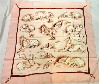 Lot 1212 - A Hermes Silk Scarf on a pale pink ground and border, decorated with whippets, 90cm by 90cm