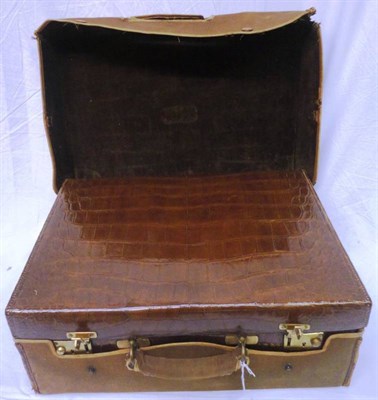 Lot 1217 - A Brown Crocodile Leather Dressing Case, fitted with three glass jars with silver fittings, stamped