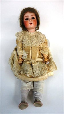 Lot 1009 - Schoenau and Hoffmeister Bisque Socket Head Doll impressed 914, with original wig, sleeping...