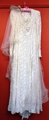 Lot 1103 - Circa 1940's Spanish Lace Mounted Wedding Dress with sweetheart bodice, long sleeves, veil and head