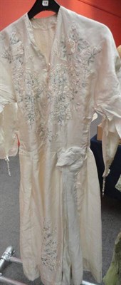 Lot 1157 - Circa 1920's Cream Silk Drop Waist Wedding Dress, embroidered with floral and bird motifs, with...