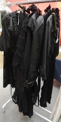 Lot 1161 - Four Late 19th Century Black Capes with black lace, chiffon, bead and ribbon appliques; Similar...