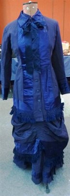 Lot 1165 - A 19th Century Navy Dress With Bustle and Matching Jacket with blue satin trims to the cuffs...