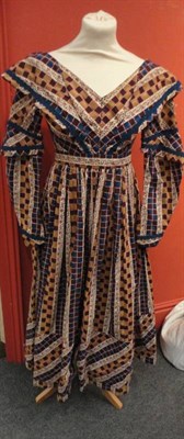 Lot 1166 - A Mid 19th Century Cotton Day Dress, printed with coloured checks of blue, burgundy and...