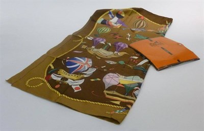 Lot 1199 - Hermes Silk Scarf 'Les Folies du Ciel' on a bronzed back ground decorated with hot air...