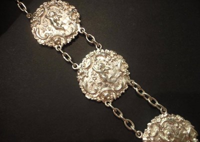 Lot 1084 - An Art Nouveau Silver Belt, comprising panels depicting cherubs within floral and scrolling...