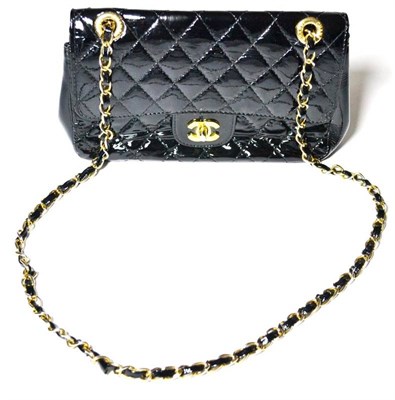 Lot 1219 - Chanel Black Patent Quilted Shoulder Bag with brass chain and patent shoulder strap, with logo...