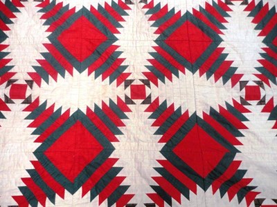 Lot 1027 - Late 19th Century Geometric Patchwork Quilt in red and green on a cream ground, 180cm by 220cm