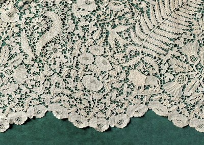 Lot 1061 - Honiton Lace Flounce decorated with ferns, birds, standing lions and floral motifs, within a...