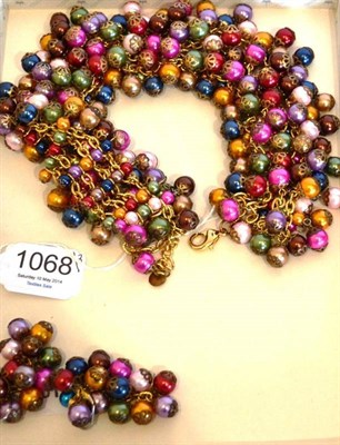 Lot 1068 - A Multi-Coloured Bead Necklace, by Butler & Wilson, the broad collar with assorted beads in cup...
