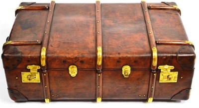 Lot 1202 - A Leather Mounted Cabin Trunk with wooden and metal mounted batons, canvas lining, bearing...