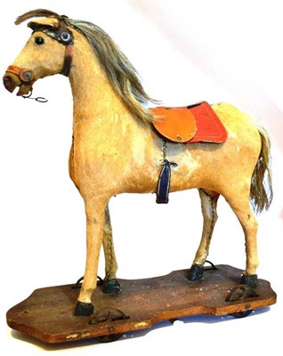 Lot 1017A - A 19th Century Carved Wood and Tan Pony Skin Pull-Along Horse with leather bridle and...
