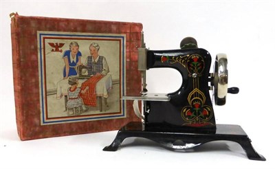 Lot 2006 - Casige German Toy Sewing Machine, black painted with floral and gilt decoration, together with...