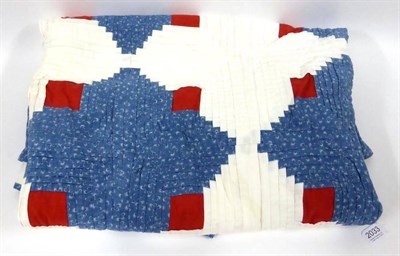 Lot 2033 - Late 19th Century Patchwork Quilt of log cabin design with a red and white centre, and blue and...