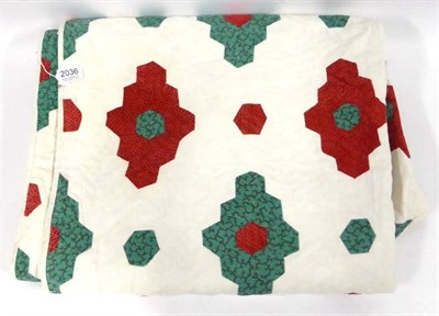 Lot 2036 - A 19th Century Green and Red Mosaic/Diamond Quilt on a white back ground with wave pattern...